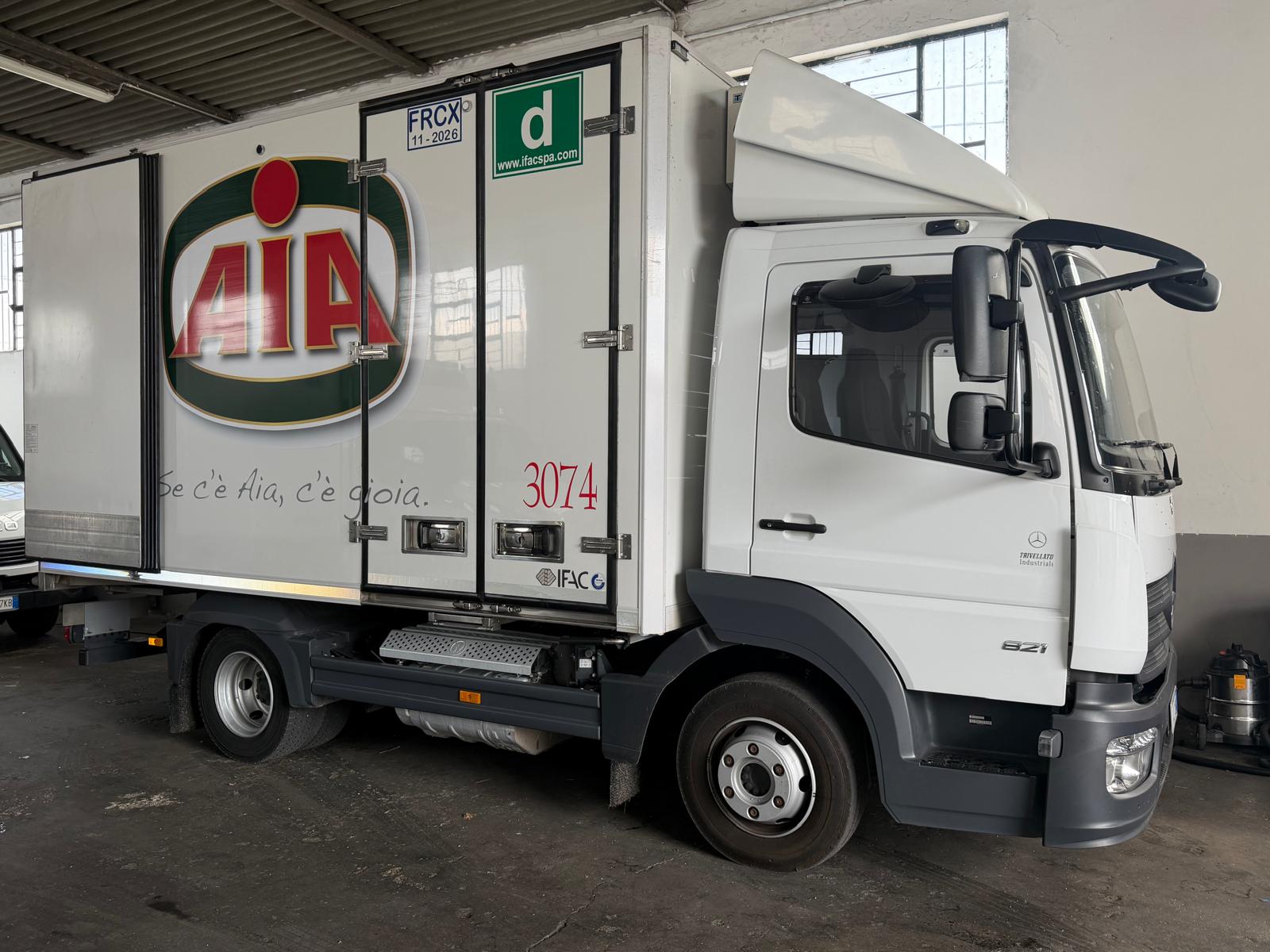 Autista Burtaccio accanto a camion frigorifero certificato
